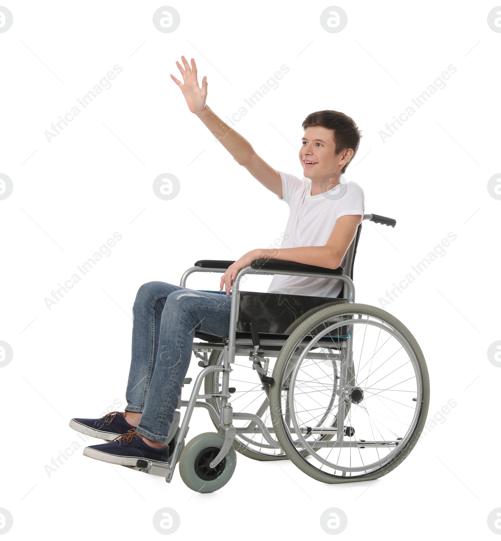 Teen boy in wheelchair on white background Photo of Teen boy in wheelchair on white background