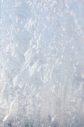 Beautiful frosty window as background, closeup. Winter morning Photo of Beautiful frosty window as background, closeup. Winter morning