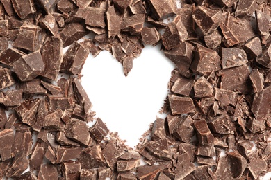 Photo of Heart made with dark chocolate crumbles on white background, top view