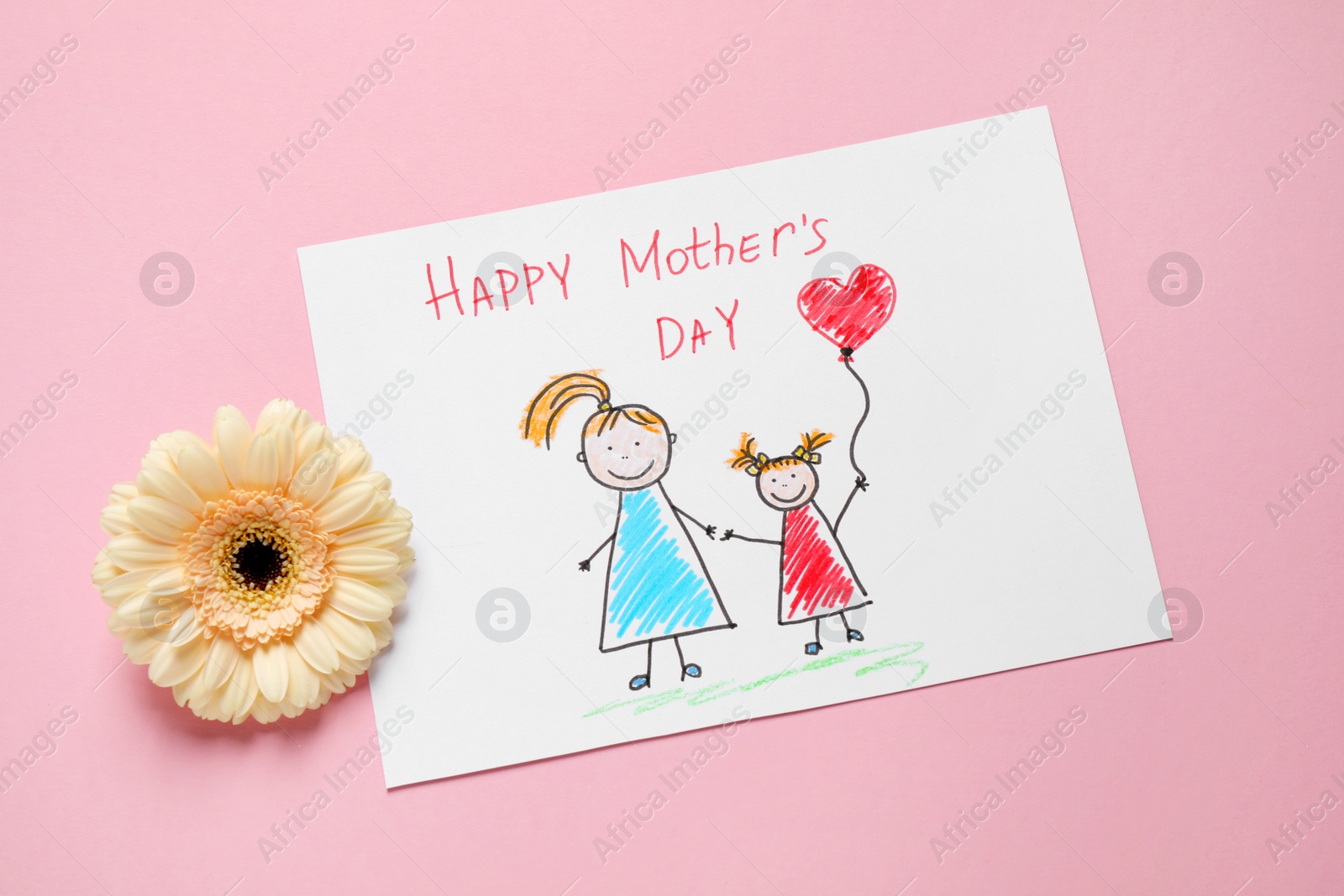 Drawing for Mother's day and flower on pastel pink background, flat lay Photo of Drawing for Mother's day and flower on pastel pink background, flat lay