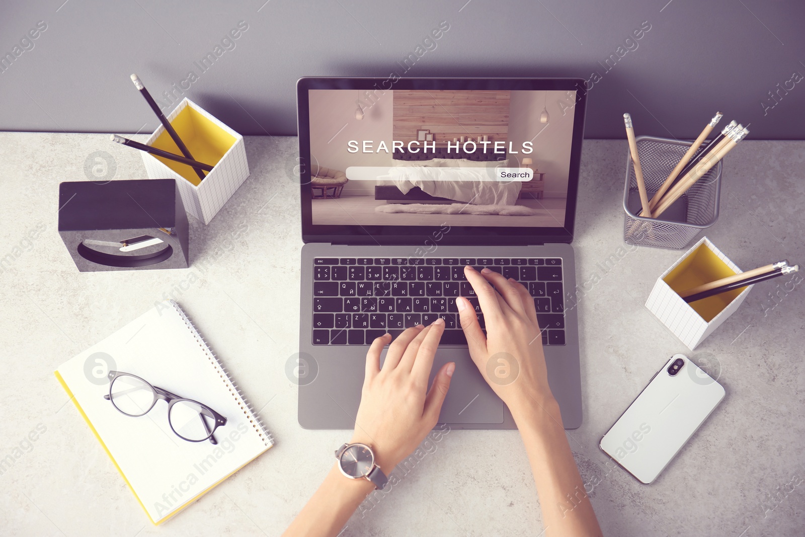 Woman searching hotel using laptop at table, top view. Booking online service Image of Woman searching hotel using laptop at table, top view. Booking online service