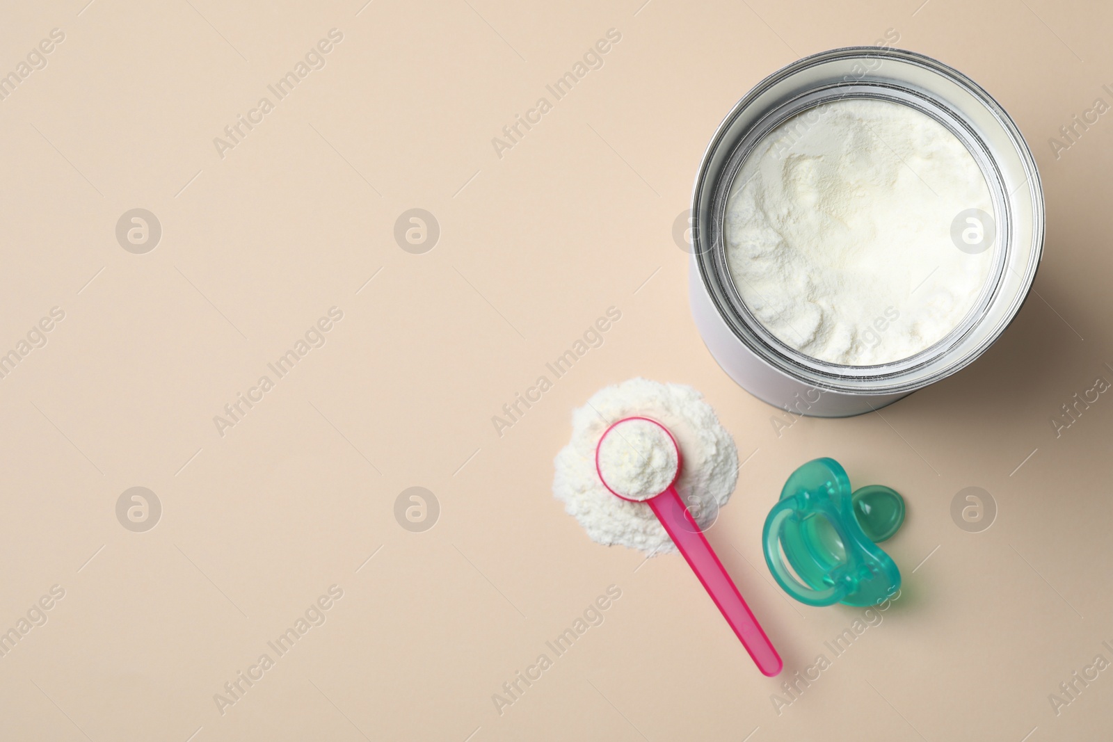 Flat lay composition with powdered infant formula on beige background, space for text. Baby milk Photo of Flat lay composition with powdered infant formula on beige background, space for text. Baby milk