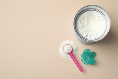 Flat lay composition with powdered infant formula on beige background, space for text. Baby milk Photo of Flat lay composition with powdered infant formula on beige background, space for text. Baby milk