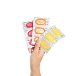 Woman holding condoms on white background, closeup Photo of Woman holding condoms on white background, closeup