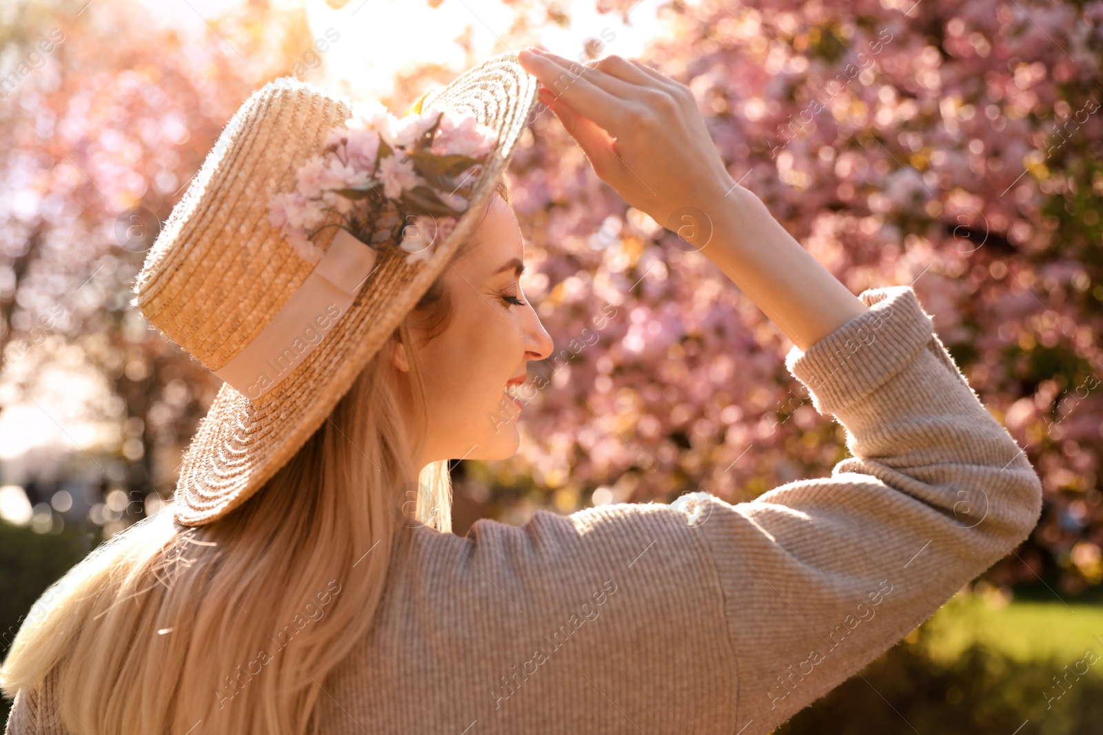 Young woman wearing stylish outfit in park on spring day. Fashionable look Photo of Young woman wearing stylish outfit in park on spring day. Fashionable look
