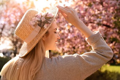 Young woman wearing stylish outfit in park on spring day. Fashionable look Photo of Young woman wearing stylish outfit in park on spring day. Fashionable look