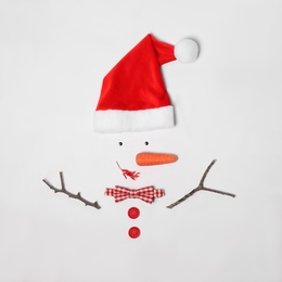 Creative snowman shape made of Santa hat and different items on white background, flat lay Photo of Creative snowman shape made of Santa hat and different items on white background, flat lay