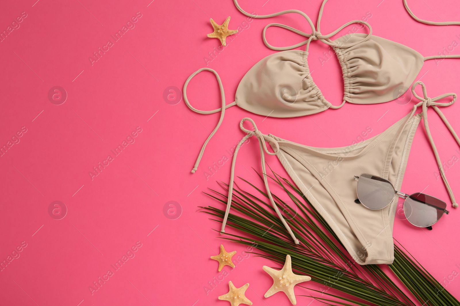 Flat lay composition with stylish bikini on pink background. Space for text Photo of Flat lay composition with stylish bikini on pink background. Space for text