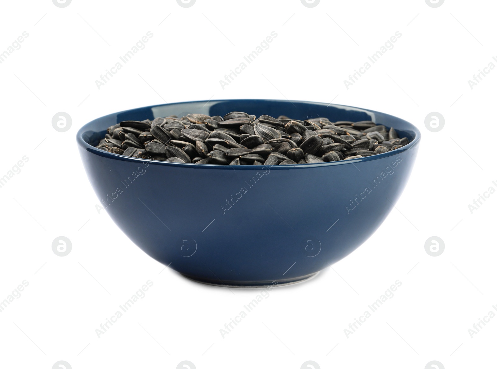 Sunflower seeds in bowl isolated on white Photo of Sunflower seeds in bowl isolated on white