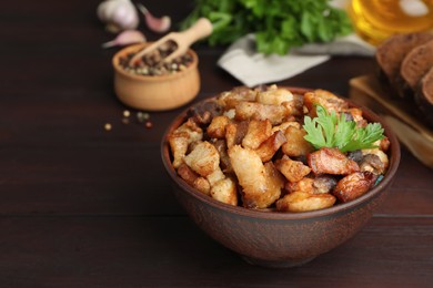 Tasty fried cracklings on wooden table, space for text. Cooked pork lard Photo of Tasty fried cracklings on wooden table, space for text. Cooked pork lard