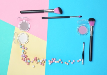 Decorative makeup products on color background Photo of Decorative makeup products on color background