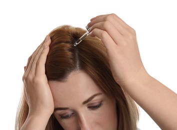 Woman applying oil onto hair on white background, closeup. Baldness problem Photo of Woman applying oil onto hair on white background, closeup. Baldness problem