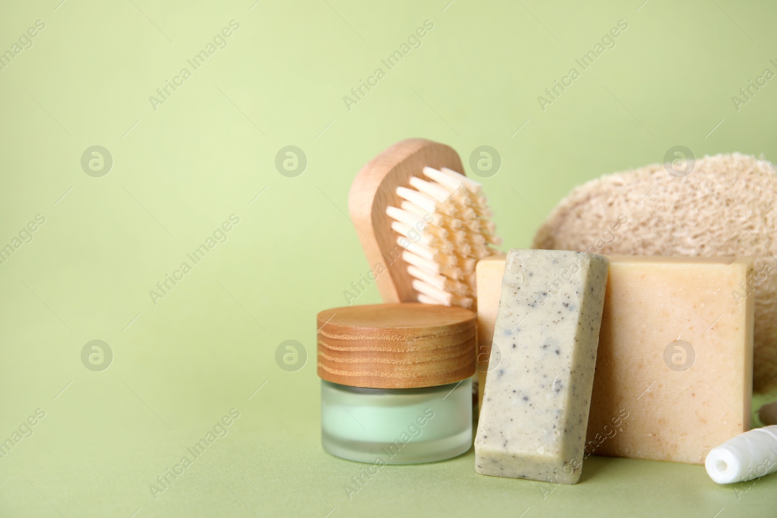Eco friendly personal care products on light green background. Space for text Photo of Eco friendly personal care products on light green background. Space for text