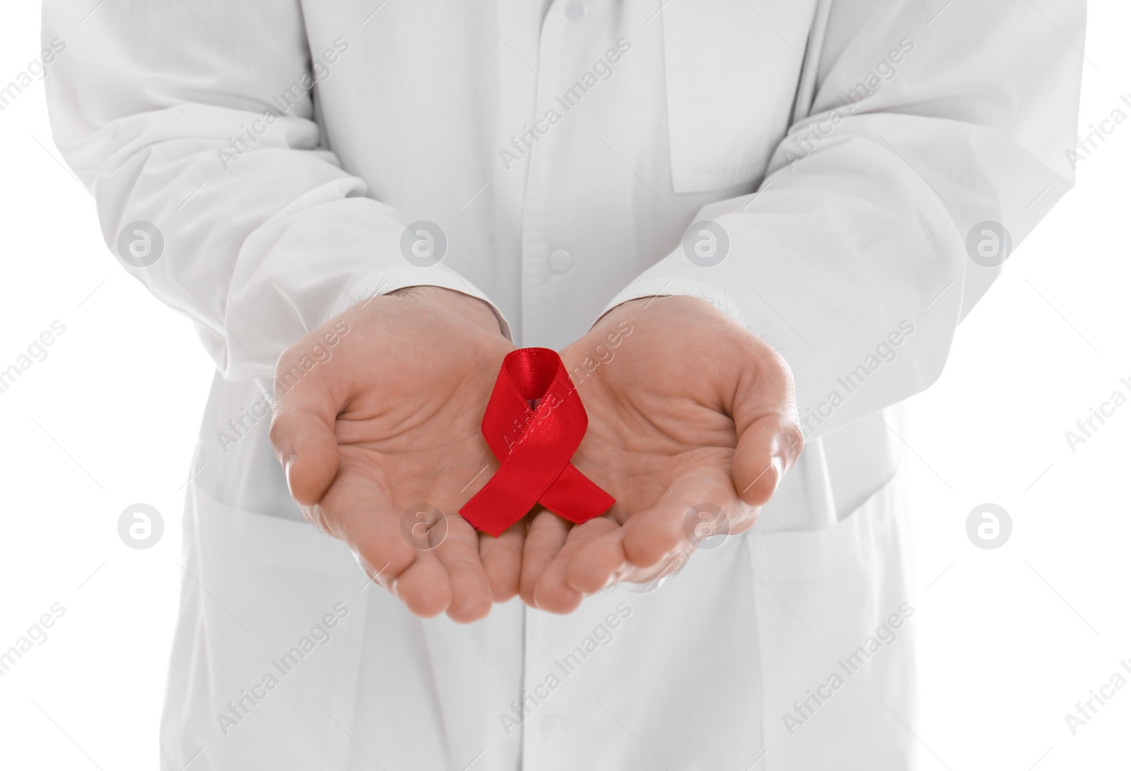 Doctor holding red awareness ribbon on white background, closeup. World AIDS disease day Photo of Doctor holding red awareness ribbon on white background, closeup. World AIDS disease day