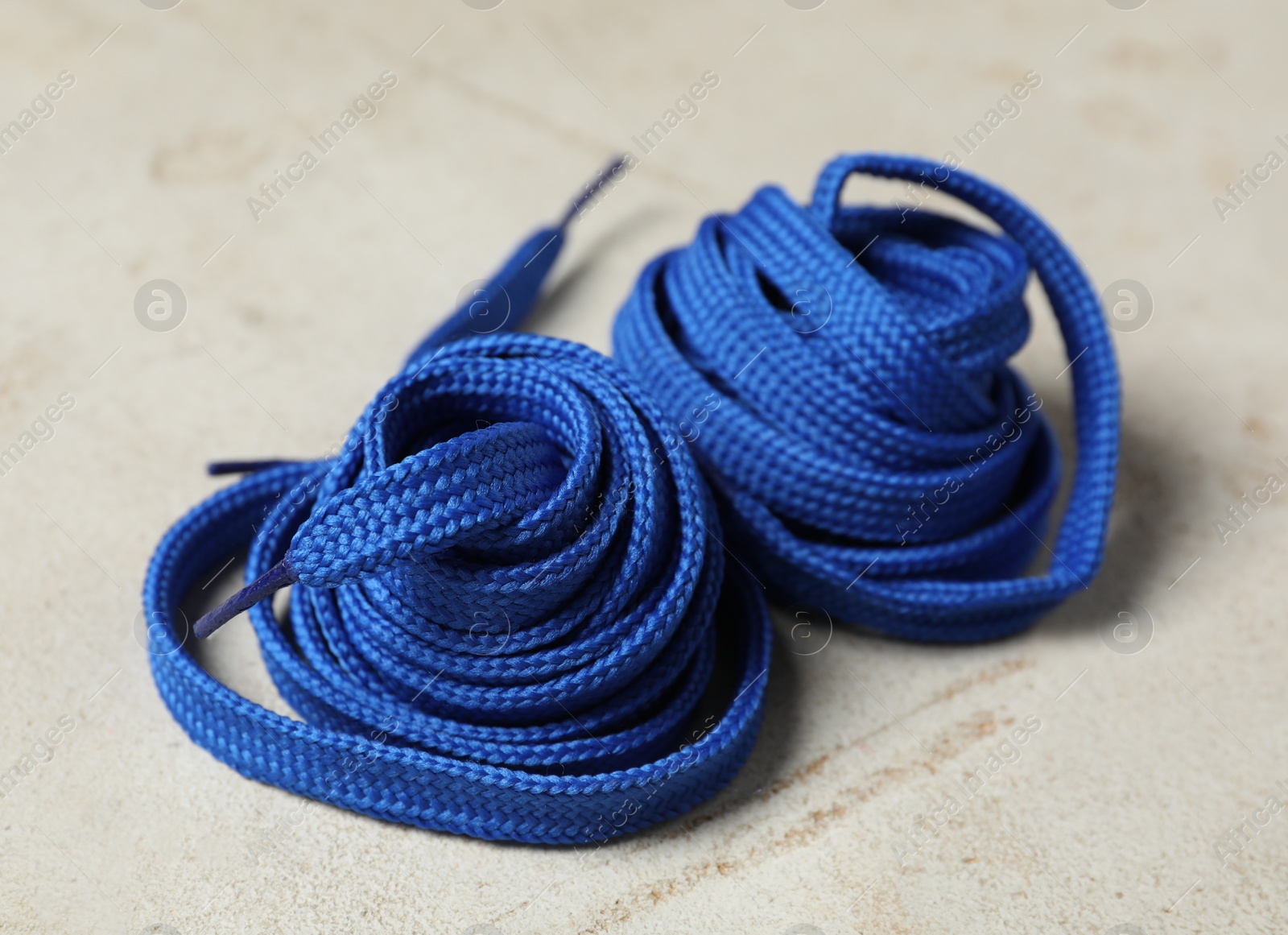 Blue shoelaces on light background. Stylish accessory Photo of Blue shoelaces on light background. Stylish accessory