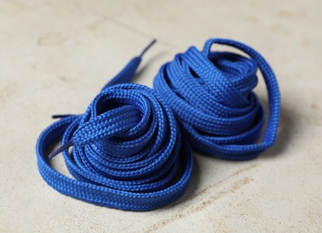 Photo of Blue shoelaces on light background. Stylish accessory