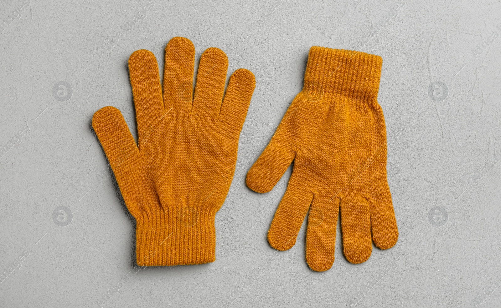 Stylish gloves on grey background, flat lay Photo of Stylish gloves on grey background, flat lay
