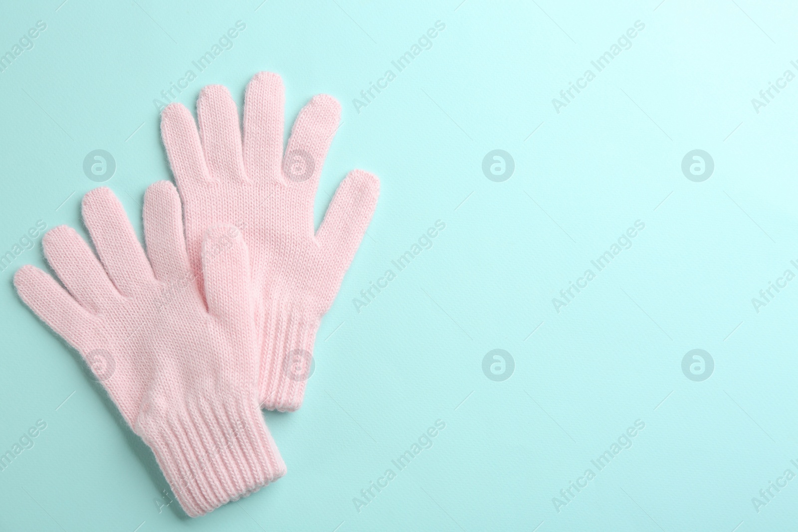 Pair of stylish woolen gloves on light blue background, flat lay. Space for text Photo of Pair of stylish woolen gloves on light blue background, flat lay. Space for text