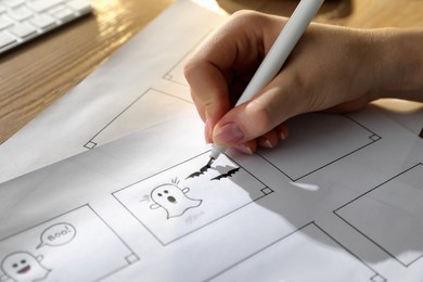 Woman drawing cartoon sketches at workplace, closeup. Pre-production process Photo of Woman drawing cartoon sketches at workplace, closeup. Pre-production process