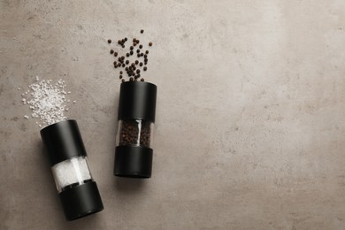 Salt and pepper shakers on light table, flat lay. Space for text Photo of Salt and pepper shakers on light table, flat lay. Space for text