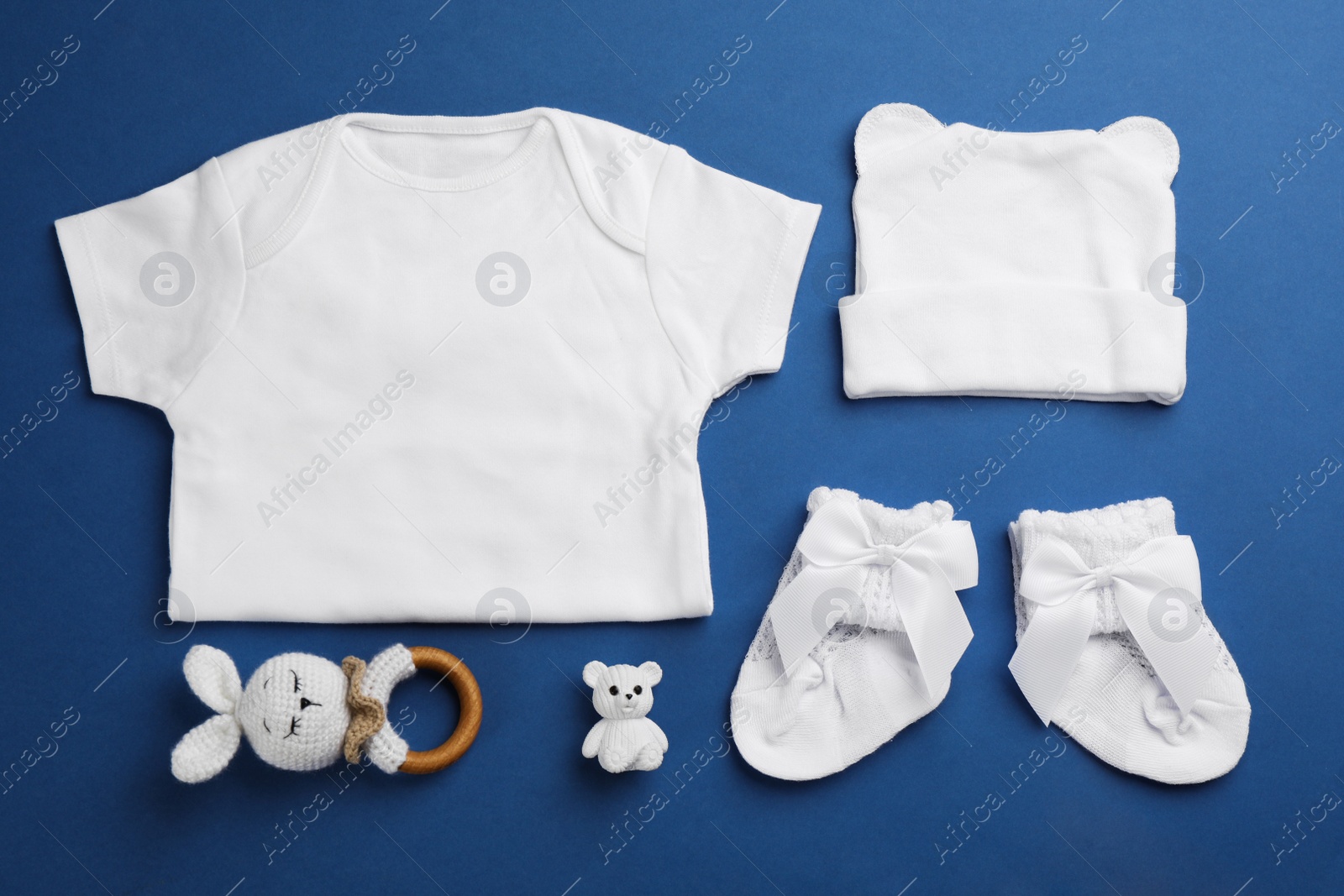 Flat lay composition with baby clothes and accessories on blue background Photo of Flat lay composition with baby clothes and accessories on blue background