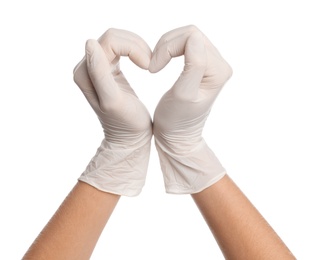 Doctor in medical gloves showing heart with hands on white background, closeup Photo of Doctor in medical gloves showing heart with hands on white background, closeup