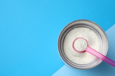 Can of powdered infant formula and scoop on color background, top view with space for text. Baby milk Photo of Can of powdered infant formula and scoop on color background, top view with space for text. Baby milk