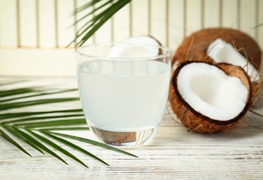 Glass of coconut water on wooden table Photo of Glass of coconut water on wooden table