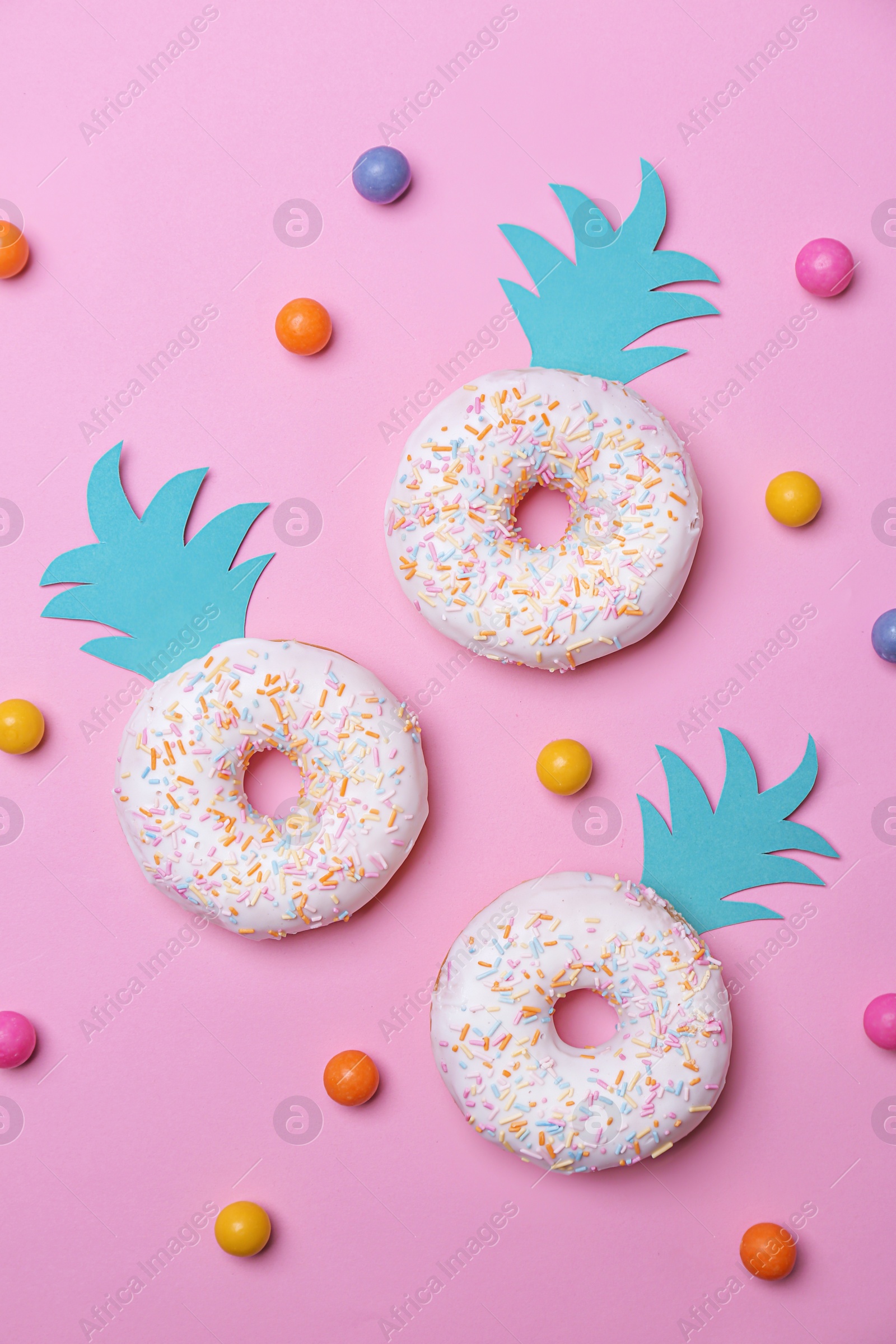 Fresh tasty donuts and candies on color background Photo of Fresh tasty donuts and candies on color background