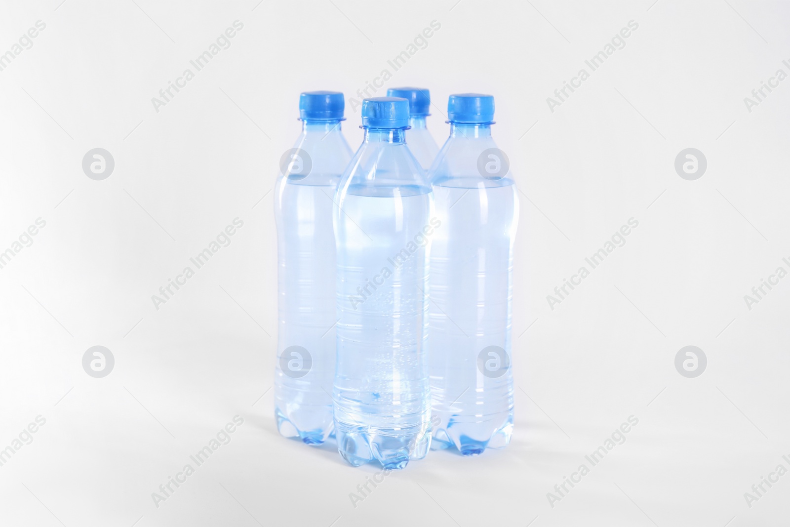 Plastic bottles with pure water on white background Photo of Plastic bottles with pure water on white background