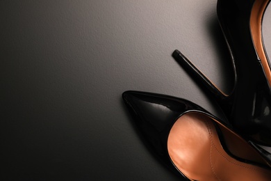Beautiful high heel shoes on black background, flat lay. Space for text Photo of Beautiful high heel shoes on black background, flat lay. Space for text