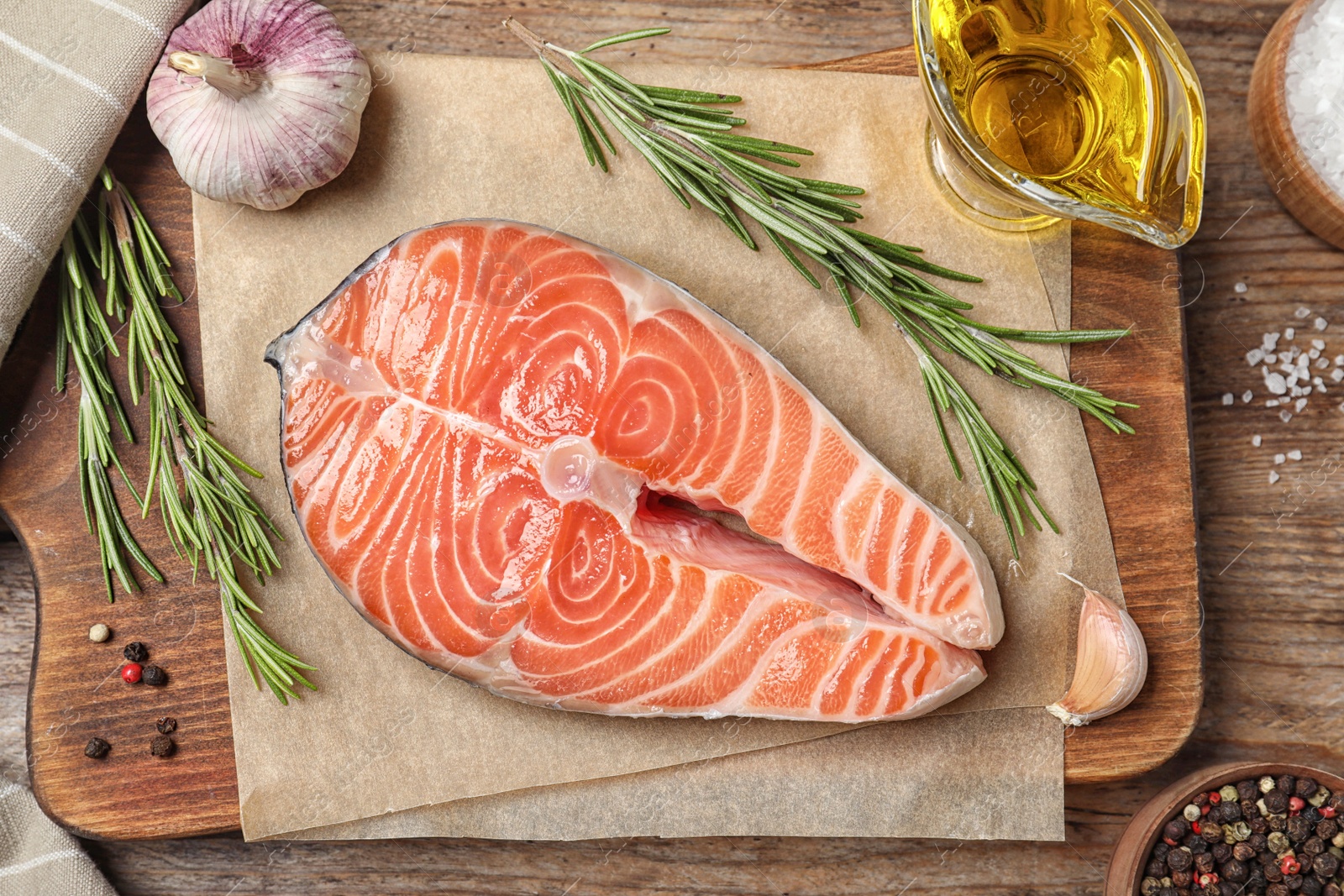 Photo of Fresh raw salmon and products on wooden table, flat lay. Fish delicacy
