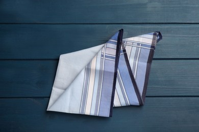 Stylish handkerchief on blue wooden table, top view Photo of Stylish handkerchief on blue wooden table, top view