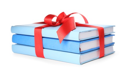 Different books tied with red ribbon isolated on white Photo of Different books tied with red ribbon isolated on white