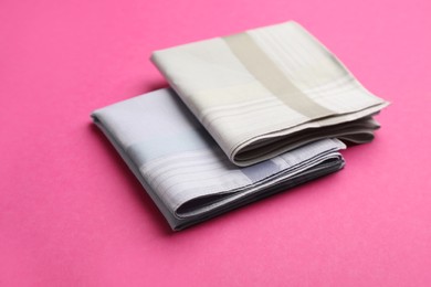 New handkerchiefs on pink background. Stylish accessory Photo of New handkerchiefs on pink background. Stylish accessory