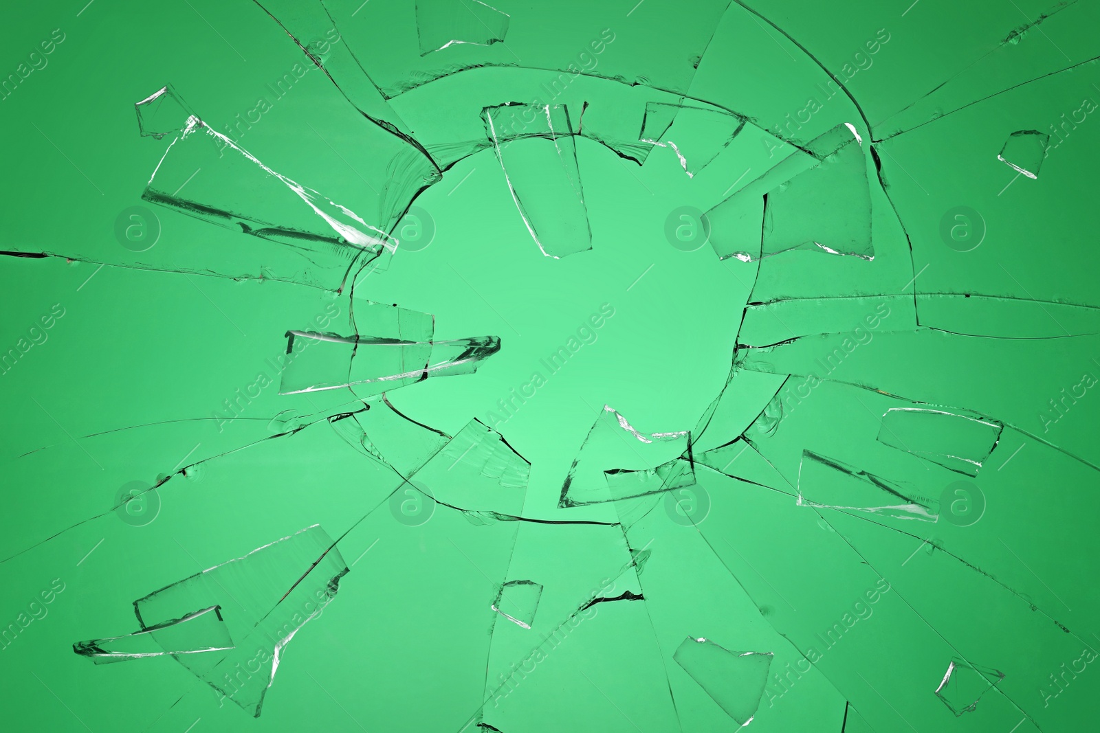 Broken glass with cracks on green background Image of Broken glass with cracks on green background