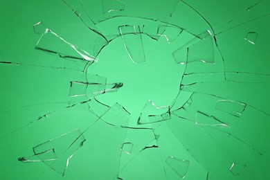 Broken glass with cracks on green background Image of Broken glass with cracks on green background