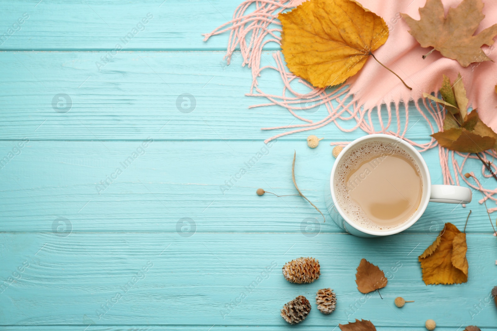Flat lay composition with cup of hot drink and autumn leaves on light blue wooden table, space for text. Cozy atmosphere Photo of Flat lay composition with cup of hot drink and autumn leaves on light blue wooden table, space for text. Cozy atmosphere