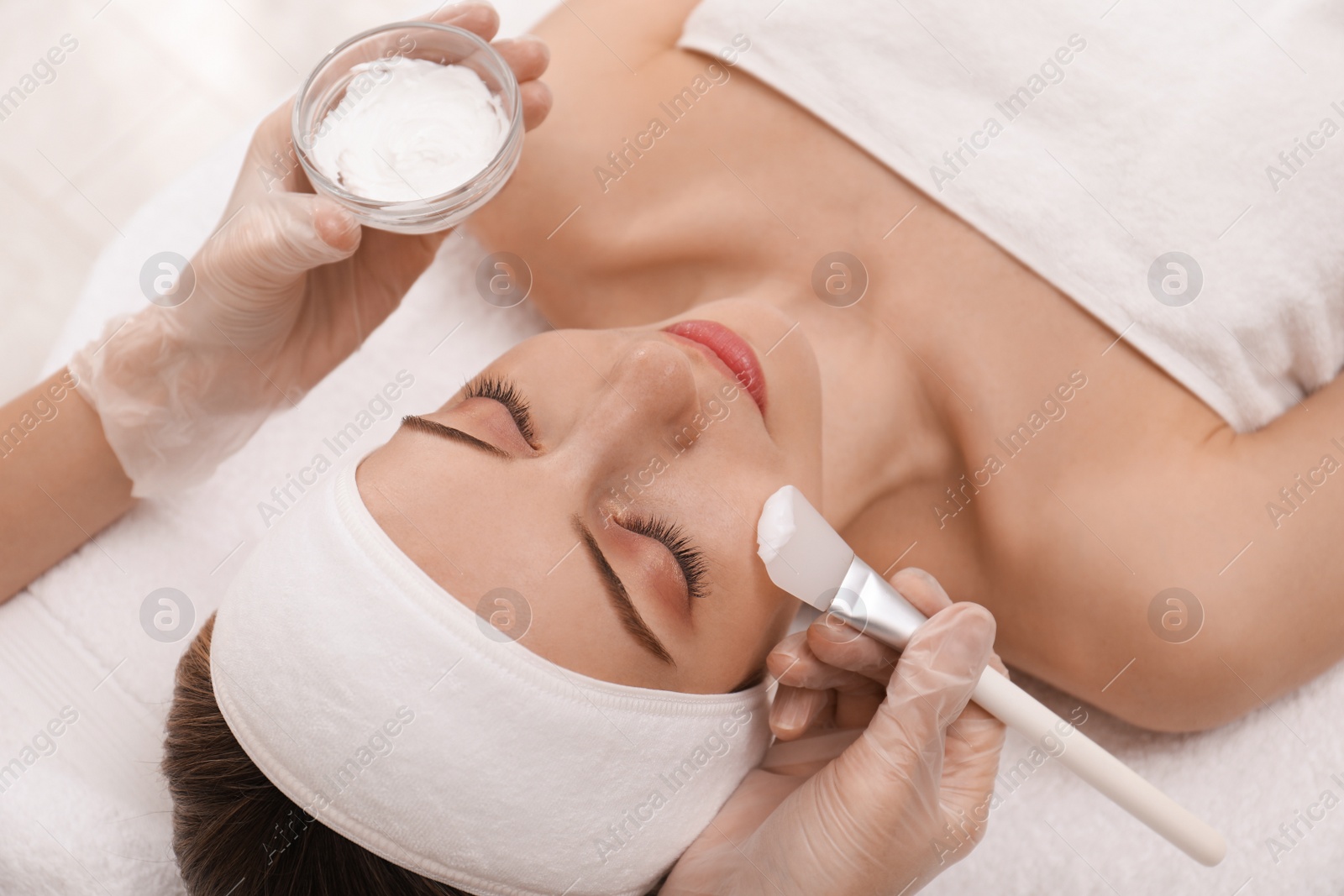 Young woman during face peeling procedure in salon Photo of Young woman during face peeling procedure in salon