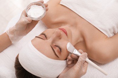 Young woman during face peeling procedure in salon Photo of Young woman during face peeling procedure in salon