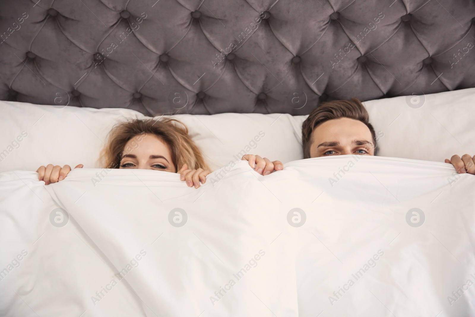Lovely young couple lying in bed at home Photo of Lovely young couple lying in bed at home