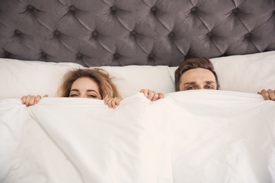 Lovely young couple lying in bed at home Photo of Lovely young couple lying in bed at home