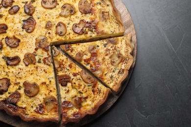 Delicious pie with mushrooms and cheese served on dark table, top view Photo of Delicious pie with mushrooms and cheese served on dark table, top view