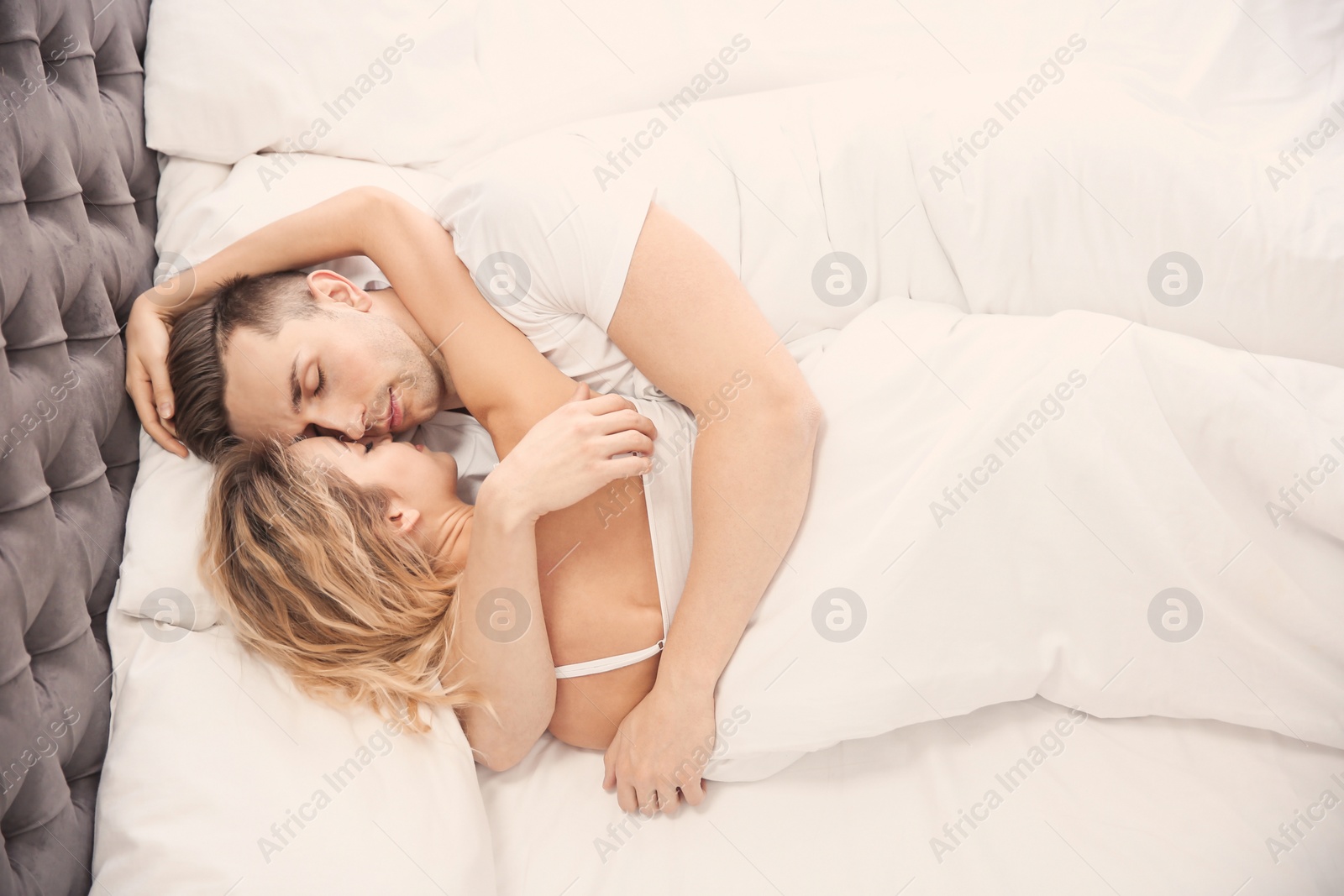 Lovely young couple sleeping in bed at home Photo of Lovely young couple sleeping in bed at home