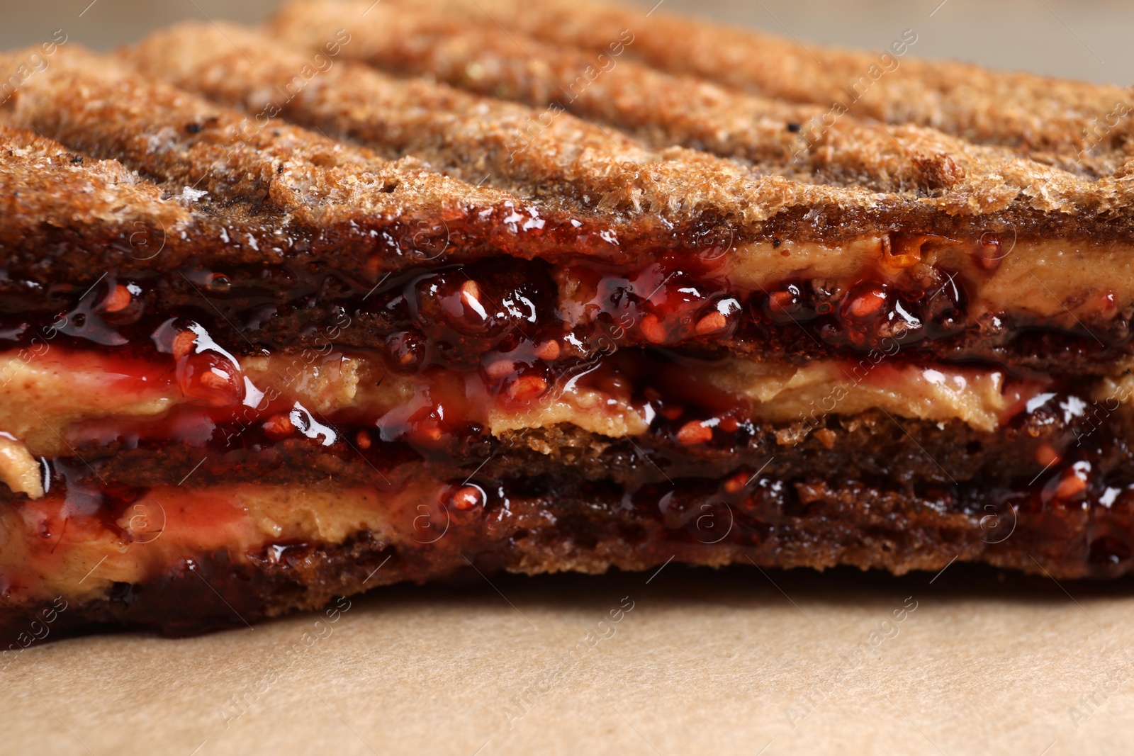 Tasty sandwich with raspberry jam and peanut butter for breakfast, closeup Image of Tasty sandwich with raspberry jam and peanut butter for breakfast, closeup