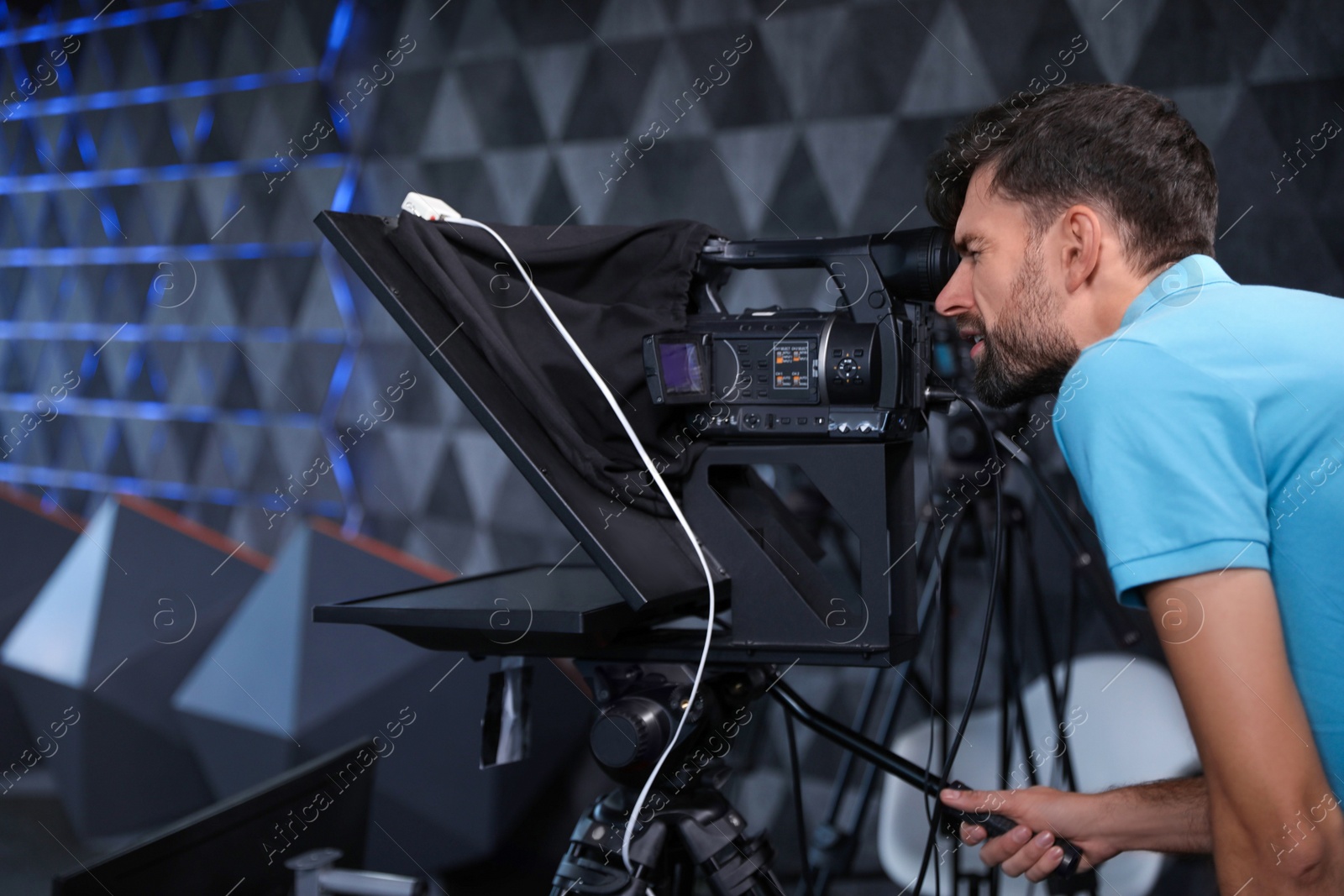 Professional video camera operator working in studio Photo of Professional video camera operator working in studio