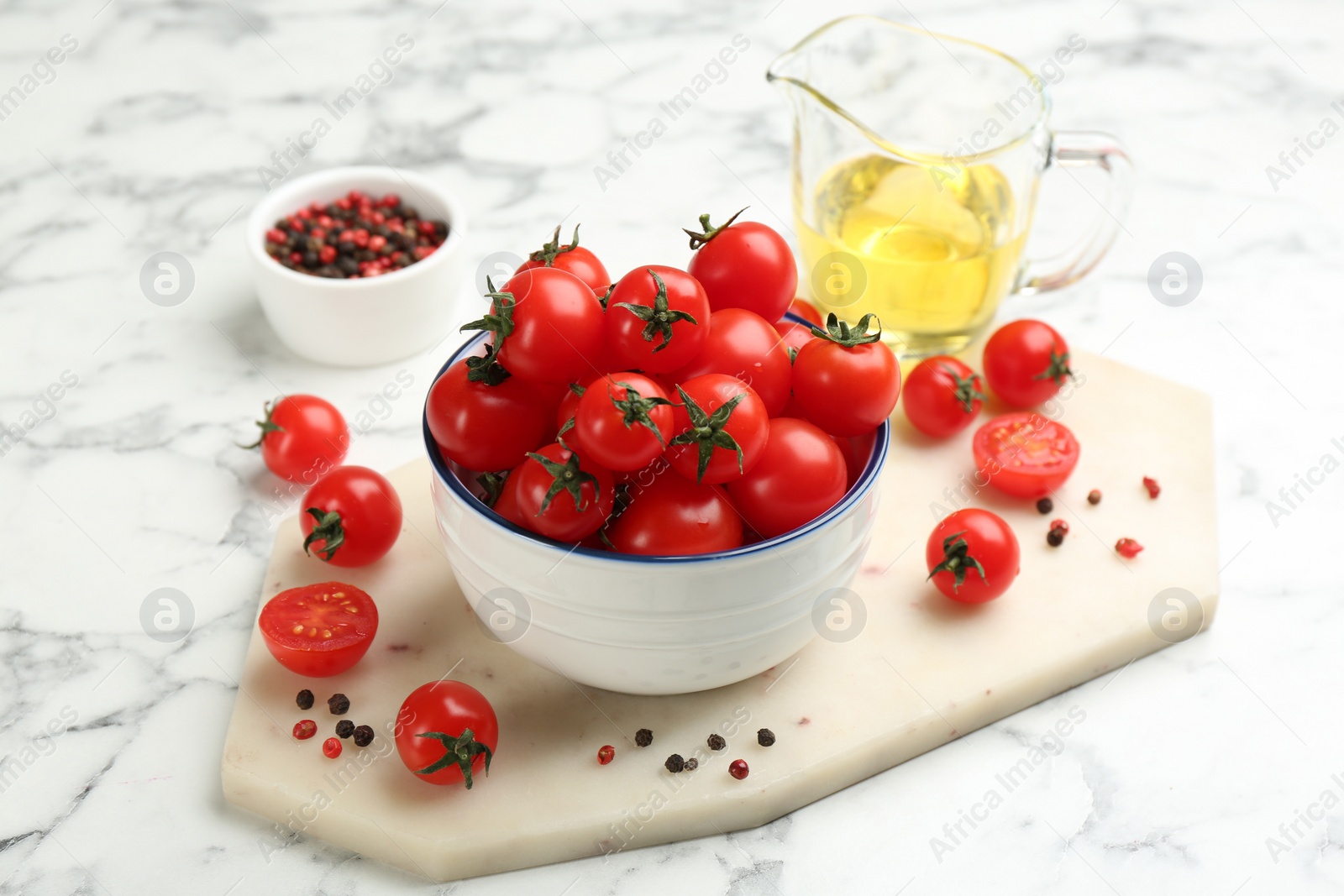 Fresh cherry tomatoes on white marble table Photo of Fresh cherry tomatoes on white marble table