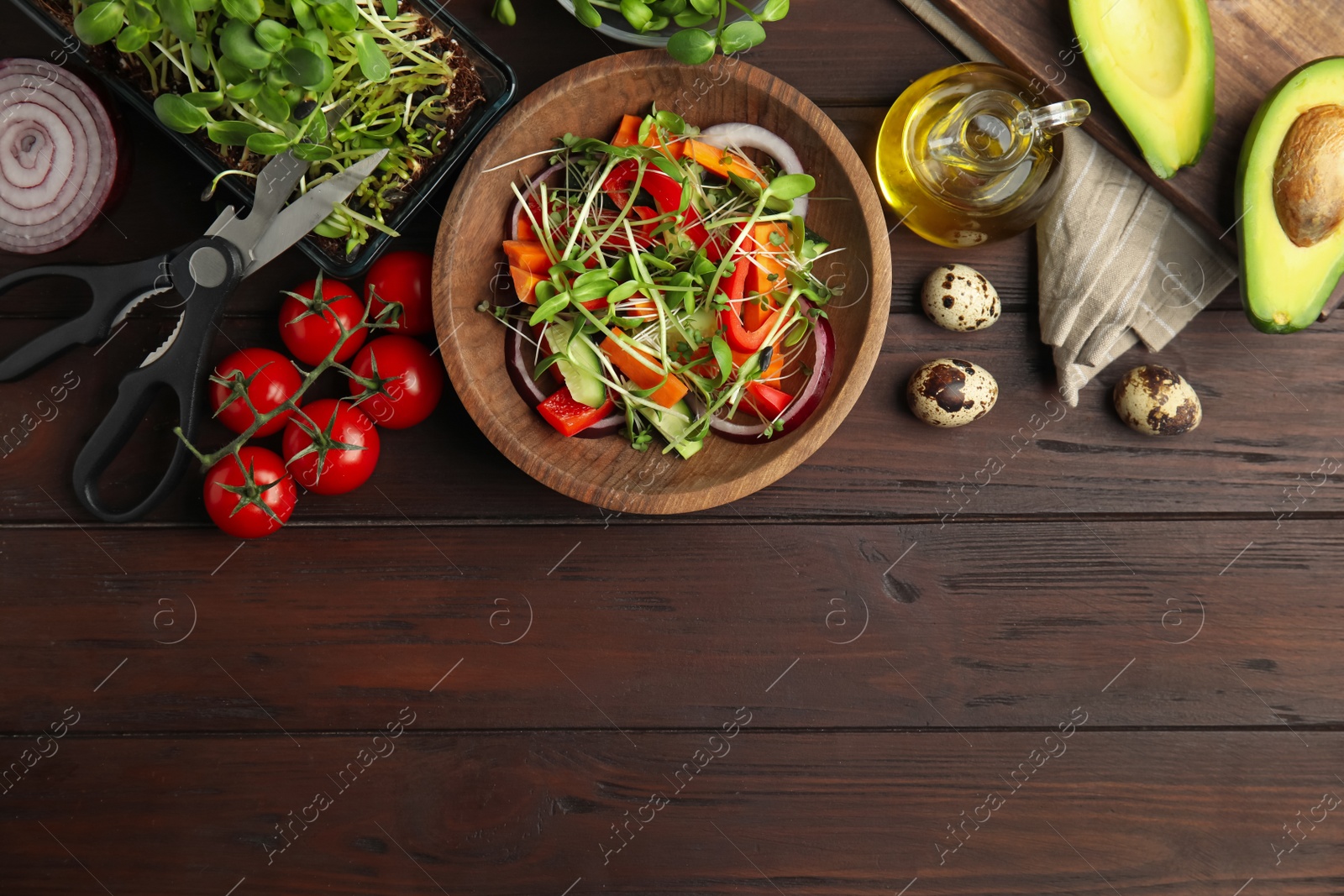 Salad with fresh organic microgreen in bowl on wooden table, flat lay. Space for text Photo of Salad with fresh organic microgreen in bowl on wooden table, flat lay. Space for text