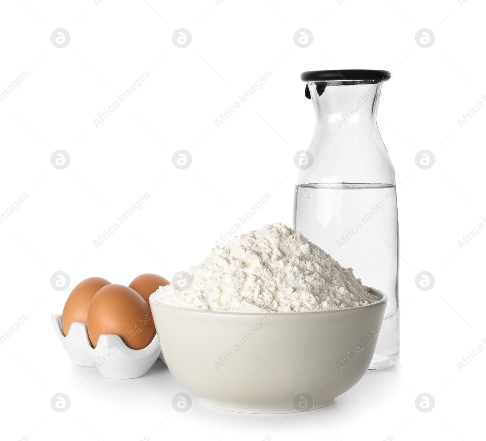 Wheat flour, eggs and bottle of water on white background Photo of Wheat flour, eggs and bottle of water on white background