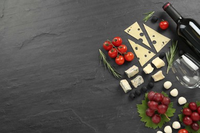 Tasty red wine and snacks on black table, flat lay. Space for text Photo of Tasty red wine and snacks on black table, flat lay. Space for text